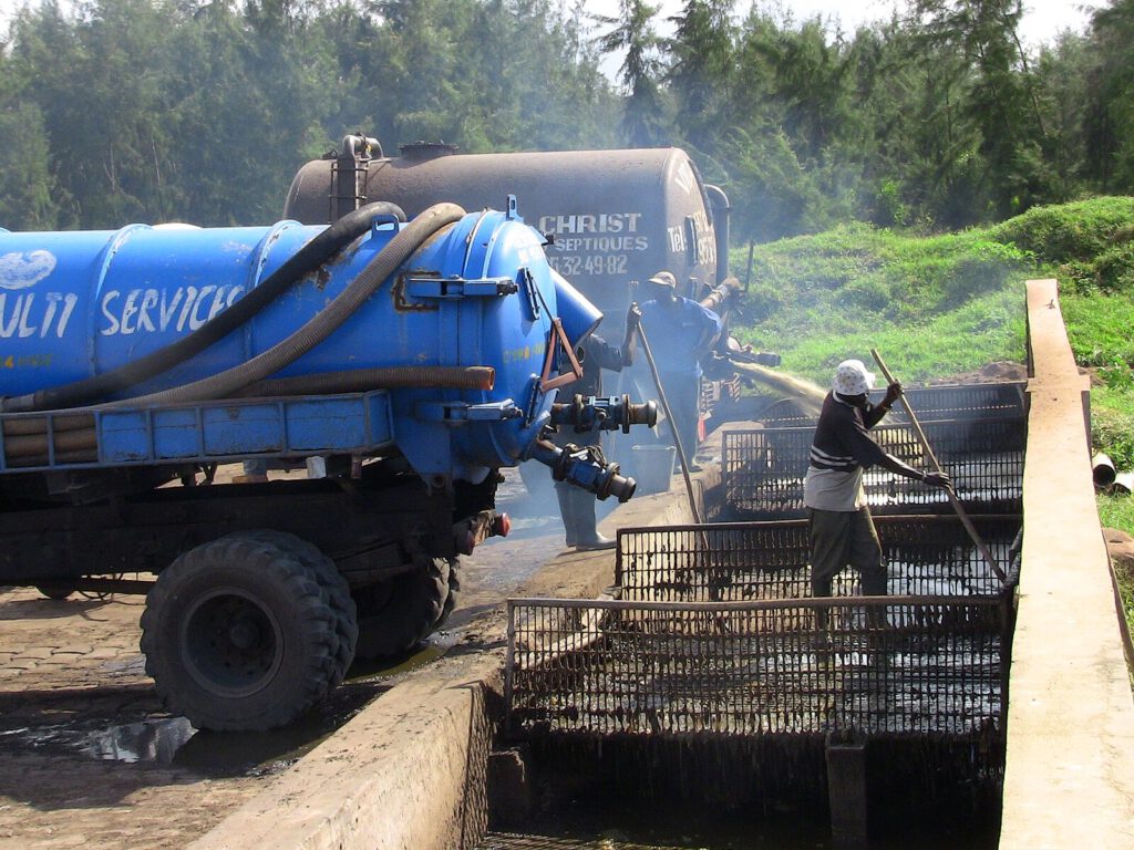 Trucks disposing faecal sludge in Benin