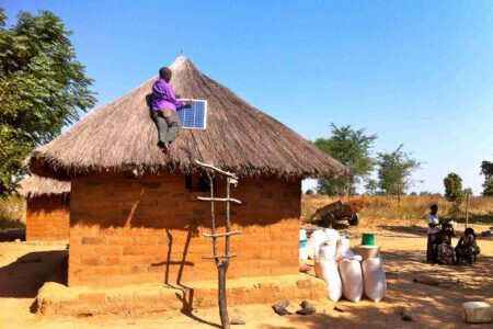 Solar module is mounted on a cabin with a thatched roof